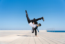 Flexible And Cool Businessman Doing Acrobatic Trick