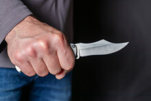 Man Holding A Knife In A Threatening Stance Ready To Fight