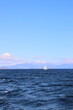 Lake Taupo with sailboat. View to snowy mount Tongariro	
