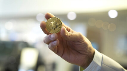 Aufkleber - Businessman hand holding glowing bitcoin sign. Stock. Virtual money concept and Financial growth concept on chart background. Hand of a businessman holding a coin bitcoin