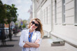 © bisonov - Stylish beautiful business woman in a white jacket on the street