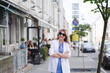 © bisonov - Stylish beautiful business woman in a white jacket on the street