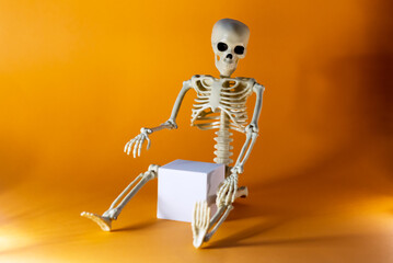 White Podium with Skeleton on Orange Background Abstract Composition in Minimal Design Halloween Concept