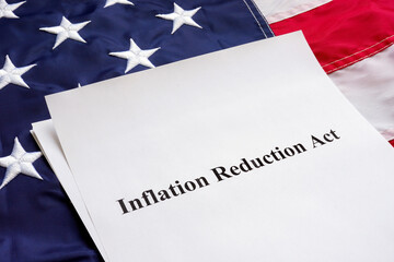Wall Mural - Papers with the Inflation Reduction Act and US flag.