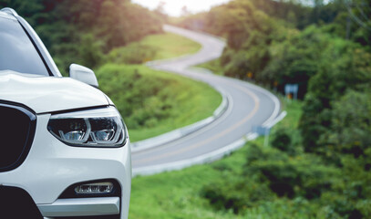 car parked on roadside In the background is a beautiful road in the shape of number 3, Nan Province, Thailand. The road is famous.