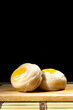Chinese pastry puff, Beans cake with salted egg yolk lay wooden plate on black background