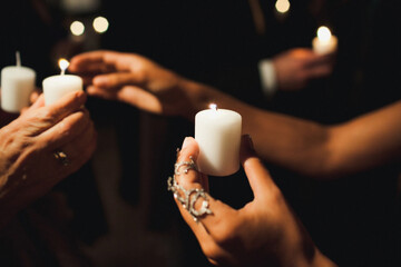 Candle in the hands of a guest at a wedding ceremony