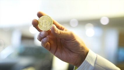 Aufkleber - Businessman hand holding glowing bitcoin sign. Stock. Virtual money concept and Financial growth concept on chart background. Hand of a businessman holding a coin bitcoin