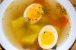 Halves of a boiled egg float in a delicious broth