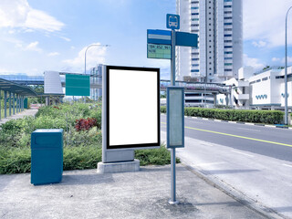 Wall Mural - Blank vertical advertising poster banner mockup at empty bus stop shelter by main road, greenery behind; out-of-home OOH vertical billboard media display space.