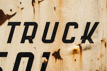 Typographic Detail Of A "Truck" Lettering On A Rusty Old Mining Truck