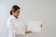 © littlestocker - Asian woman holding white board. Advertising copyspace