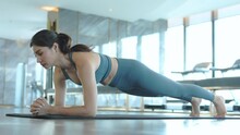Asian Woman Wearing Sportswear Doing Planking Exercise At Sports Club, Person Doing Exercise