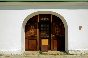 Wall Mural - Old wooden gate on white wall in Kyiv Pechersk Lavra in Kyiv Ukraine