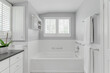 © Bryan - white modern country farmhouse bathroom interior design plantation shutters granite countertop sink tulips stand in shower and tub
