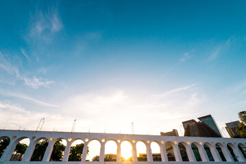 Fototapete - Sun Shines Through Landmark Lapa Arches in Rio de Janeiro City Downtown
