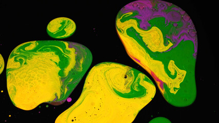 Poster - Liquid paint texture in slow motion isolated on black background. Stock footage. Artistic background with mixing of bright colors on black surface, fluid art concept.