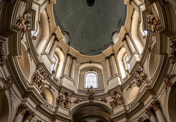 An ancient cathedral with gold molding, inside view.