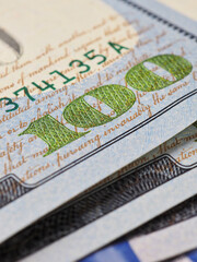 Wall Mural - american banknotes of one hundred dollars. fragment of bills close-up. new sample money. focus on nu