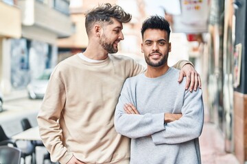 Young couple smiling confident hugging each other at street