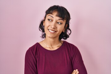 Sticker - Young beautiful woman standing over pink background looking away to side with smile on face, natural expression. laughing confident.