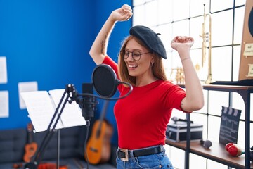 Poster - Young redhead woman artist singing song at music studio