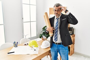 Poster - Middle age hispanic business man holding paper blueprints worried and stressed about a problem with hand on forehead, nervous and anxious for crisis