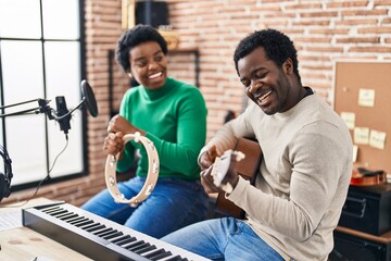 Poster - African american man and woman music group singing song playing guitar and tambourine at music studio