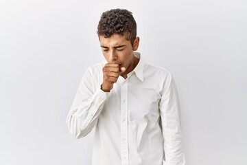 Poster - Young handsome hispanic man standing over isolated background feeling unwell and coughing as symptom for cold or bronchitis. health care concept.