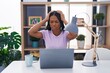 African american woman with braids using laptop at home suffering from headache desperate and stressed because pain and migraine. hands on head.