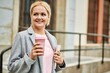 © Krakenimages.com - Young blonde businesswoman smiling happy drinking coffee at the city.