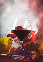 Red Wine Cabernet Franc In  Glass On  Dark Background With Autumn Grape Leaves