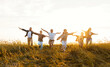 © JenkoAtaman - Happy family running in field in summer evening