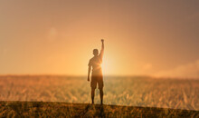 Happy Man Standing On A Hill Facing The Sunset Putting Her Arms, Thumbs Up Feeling Happy, Energized, And Free. Finding You Inner Strength Concept.	
