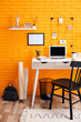 © New Africa - Stylish home office interior with comfortable workplace near orange brick wall