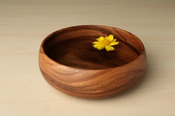 Wall Mural - Water with flower in bowl on wooden table