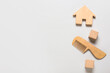 © Pixel-Shot - Wooden hair comb for baby, cubes and house on light background