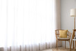 © Pixel-Shot - Interior of light room with wicker armchair, table and standard lamp