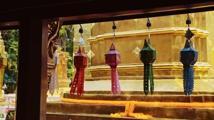 Wall Mural - Colourful Prayer Lanterns Hanging at a Thailand Buddhist Temple at Chiang Mai, Wat Phra Singh, Used for Religious Ceremonies with Gold at a Beautiful Famous and Popular Place to Visit