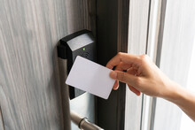 Woman Hand Using Electronic Smart Key Card To Unlock Door In Hotel Or House. Digital Lock, Door Access Control, Contactless Concept. Closeup, Copy Space