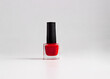 © Philippova - Red nail polish bottle on white background
