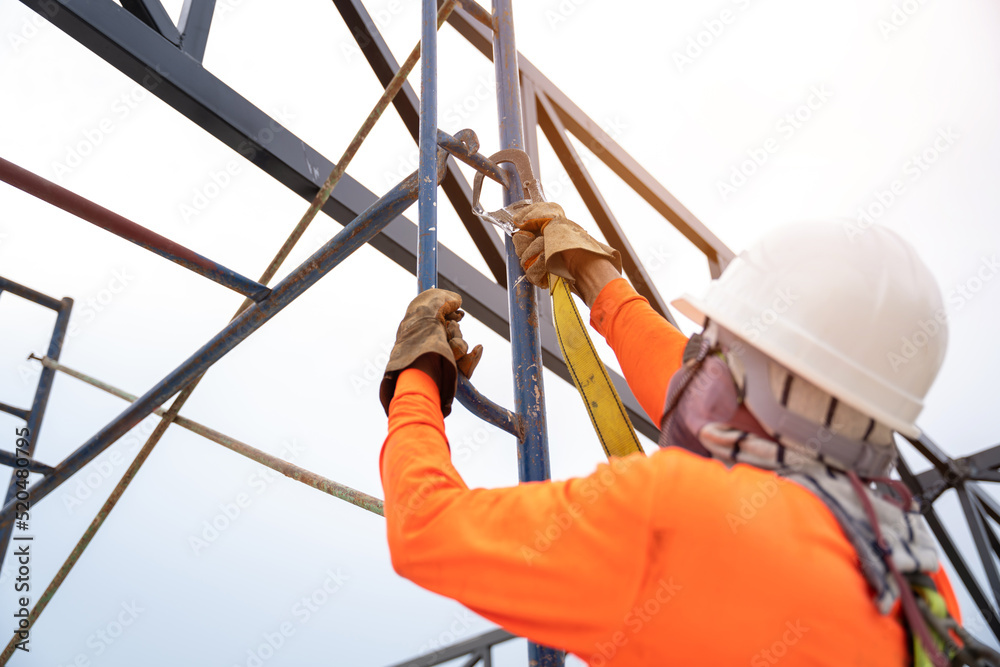 Construction workers are using safety equipment to prevent falls from ...