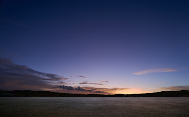empty asphalt floor with sunset sky