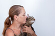 © Tatiana Foxy - Portrait of caucasian middle aged woman of 40s holding cat on white background looking aside