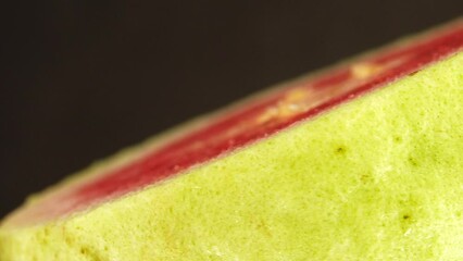 Wall Mural - 4K macro close up organic sliced guava rotating plate isolated on black background