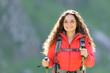 © Antonioguillem - Happy hiker walking towards camera in the mountain