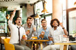© bugarskipavle3 - Friends cheering. Four happy soccer fans drinking beer at the pub