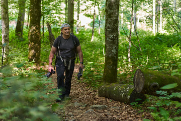 Nature photographer hiking in the forest