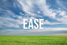 EASE - Word On The Background Of The Sky With Clouds.