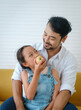 © Success Media - Father sees his daughter eating apples and is very happy.